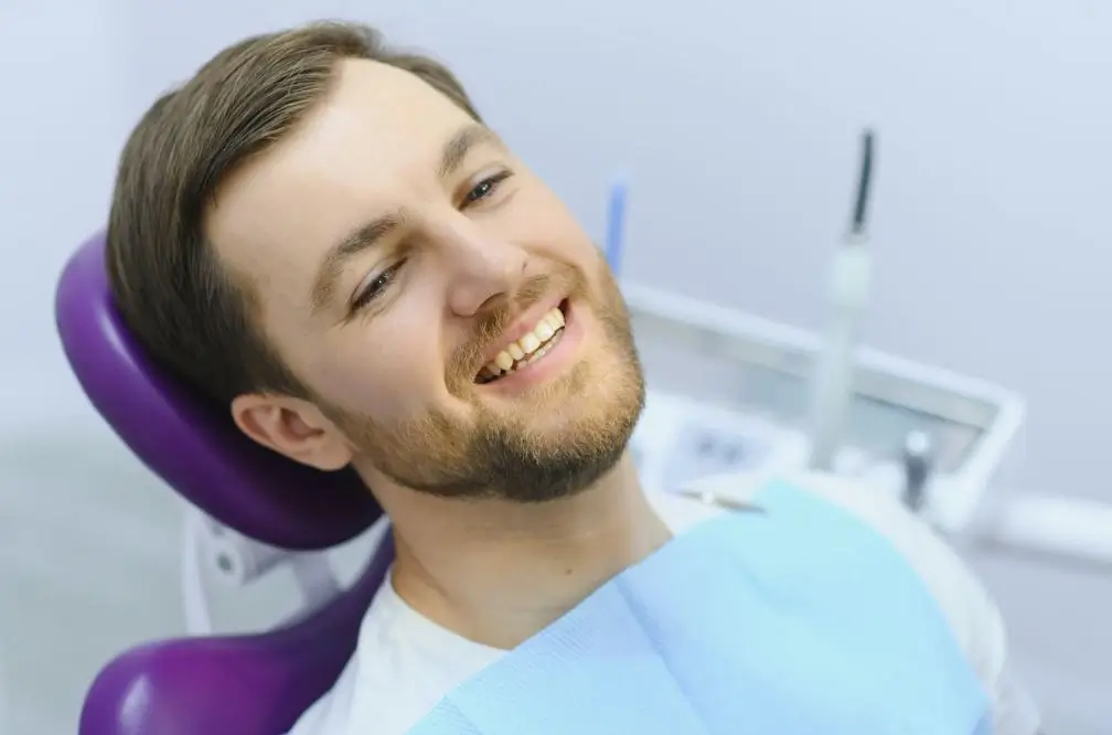 Happy man in a dental exam chair.