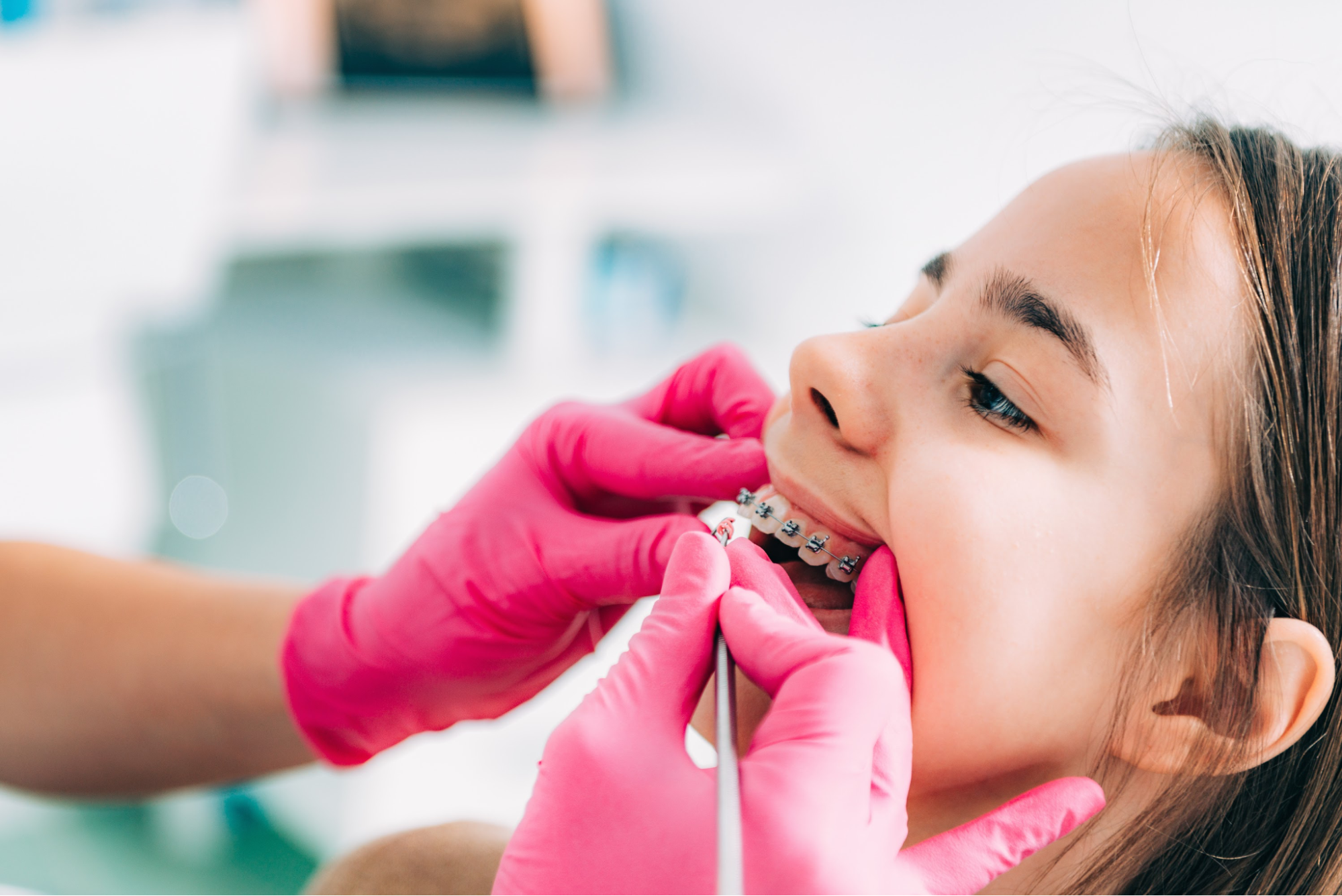 A child getting her braces checked.